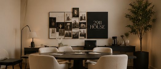 Visualization of the Club corner: a round black table with cream chairs under a wall of framed prints.